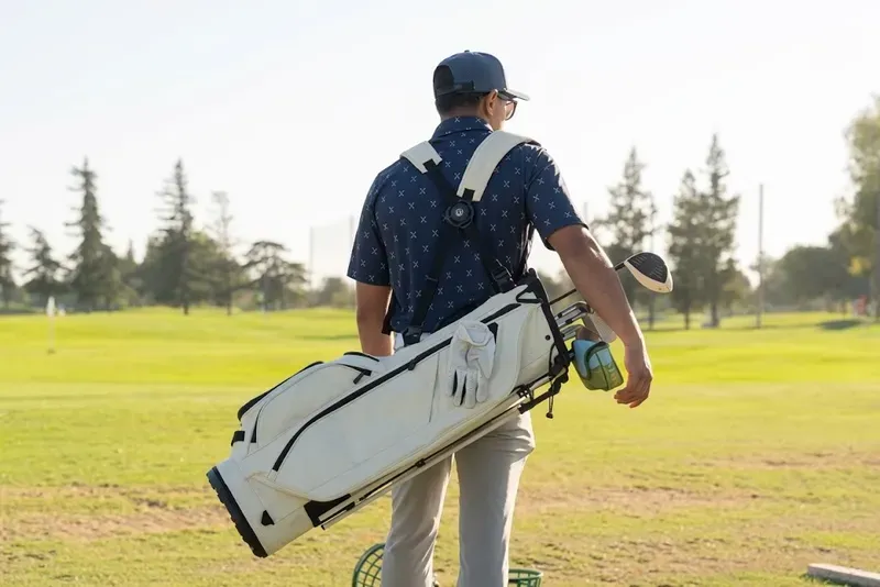 Golf stand bag carried across a fairway