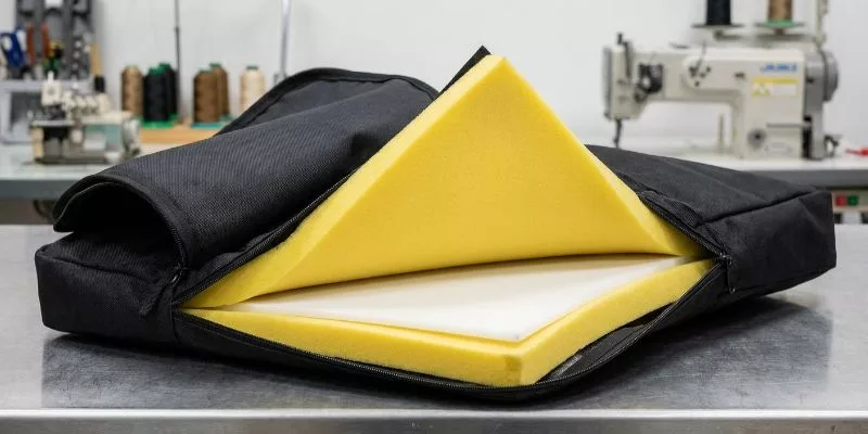 Deconstructed duffle bag base showing nylon, EVA foam, and PP plastic board layers